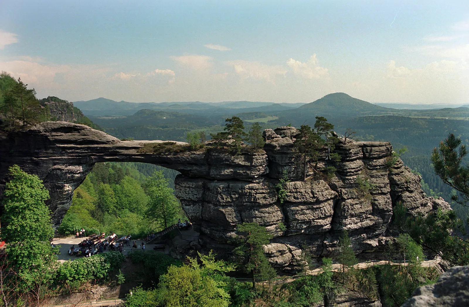 The natural sandstone arch of Pravčická brána above the forests of Bohemian Switzerland.