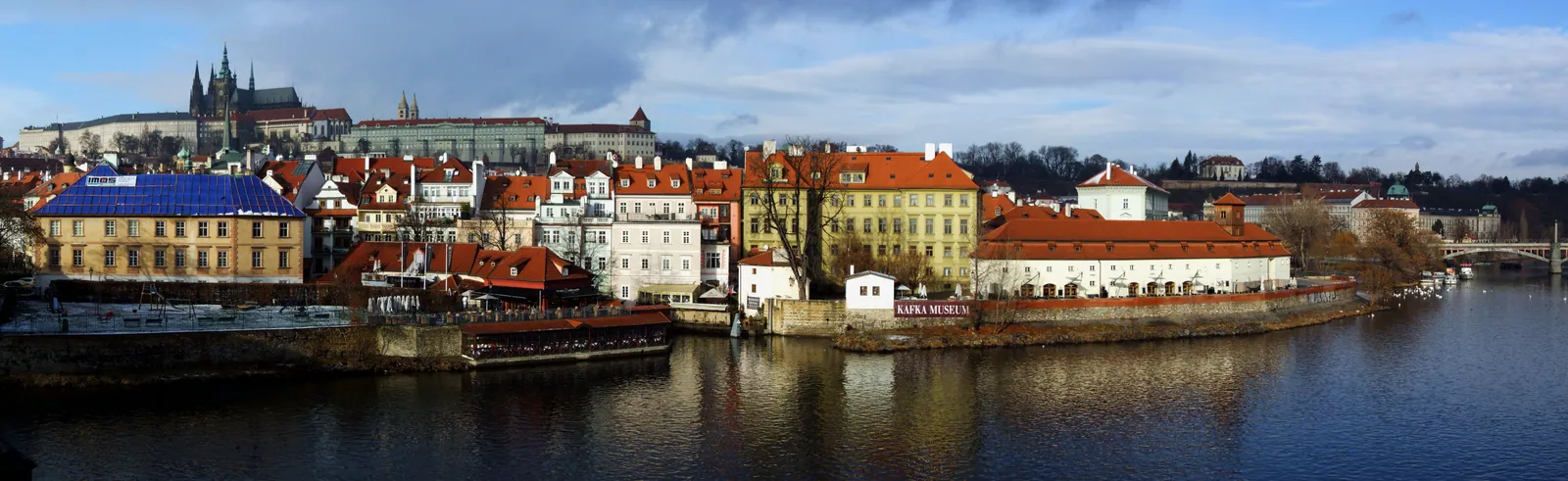 The Vltava river and the rooftops of Prague seen from Charles Bridge.